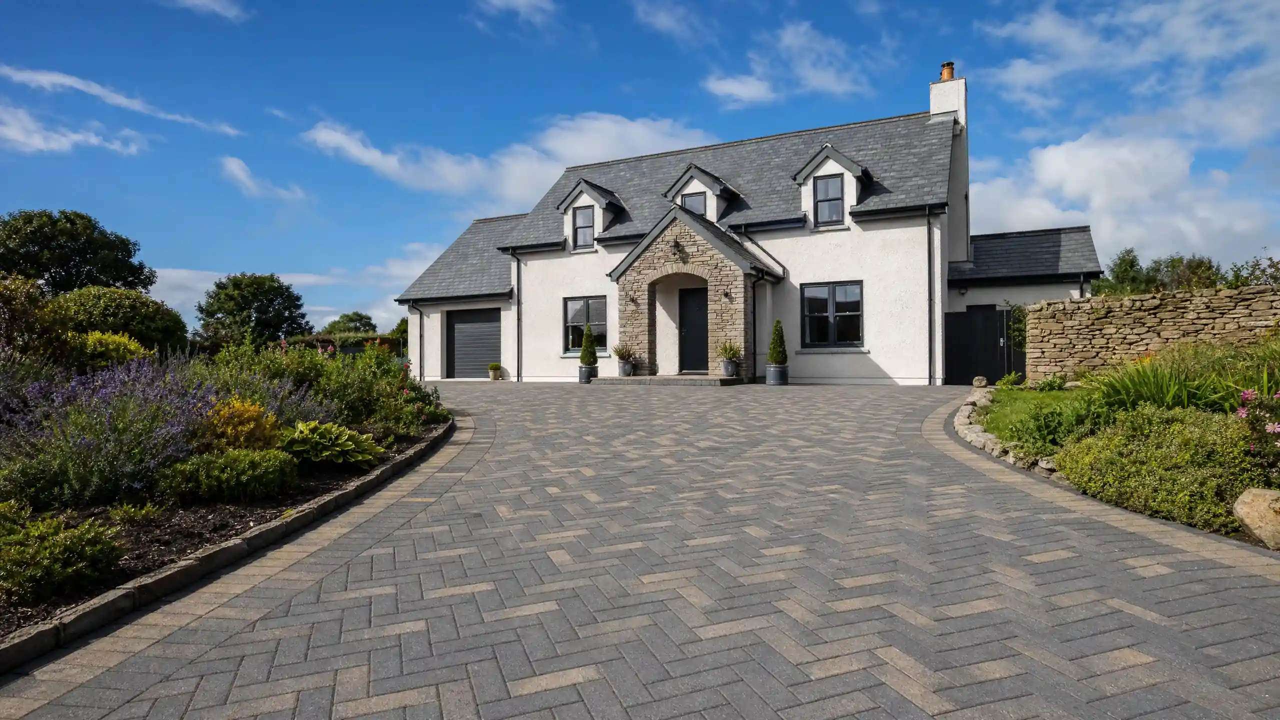 Herringbone block-paved driveway and slate roof on a Cornish cottage — AVA Building Truro