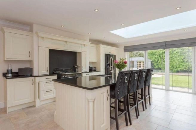 Modern fitted kitchen with central island and skylight — AVA Building & Construction, Truro