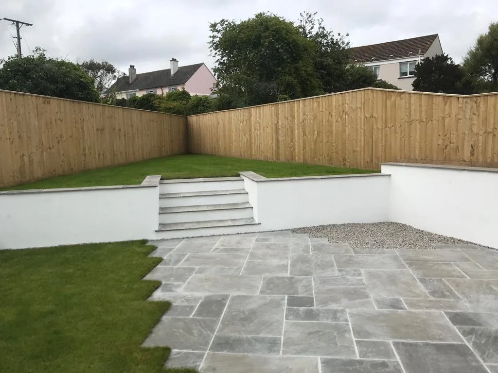 New garden patio with slate paving, lawn and timber fencing — AVA Building, Truro Cornwall